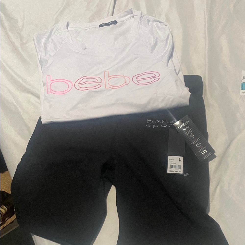 Bebe White Top with Pink Logo and Black bike shorts pockets in the sides